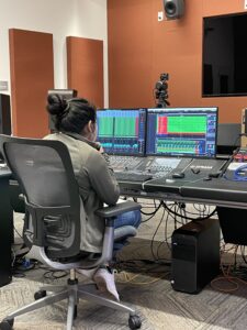 Dora sitting in front of the recording console